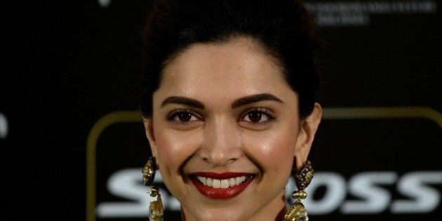 Bollywood actress Deepika Padukone poses on the green carpet as she arrives to attend the final day of the 16th International Indian Film Academy (IIFA) Awards at the Putra Stadium in Kuala Lumpur on June 7, 2015. AFP PHOTO / MANAN VATSYAYANA (Photo credit should read MANAN VATSYAYANA/AFP/Getty Images)