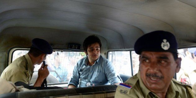 Vismay Shah (C) sits inside a police vehicle after a court sentenced him to five years in prison in a hit-and-run case in Ahmedabad on July 13, 2015. Shah, 27, was found guilty in case where his BMW car hit a two wheeler vehicle, killing two people. AFP PHOTO / Sam PANTHAKY (Photo credit should read SAM PANTHAKY/AFP/Getty Images)