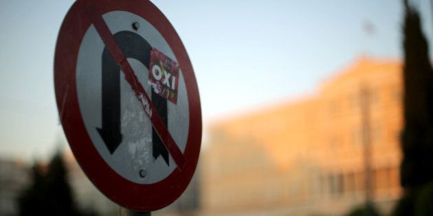 ATHENS, GREECE - JULY 13: An 'Oxi' (No) sticker from lastweeks referendum adorns a No U turns sign outside the Greek parliament as protesters to demonstrate against austerity after an agreement for a third bailout with eurozone leaders on July 13, 2015 in Athens, Greece. The bailout is conditional on Greece passing agreed reforms in parliament by Wednesday which includes streamlining pensions and rasing more raise tax revenue. (Photo by Christopher Furlong/Getty Images)