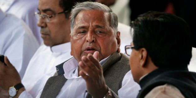 Samajwadi Party President Mulayam Singh Yadav attends the oath taking ceremony of his son Akhilesh Yadav as the Chief Minister of Uttar Pradesh state in Lucknow, India, Thursday, March 15, 2012. Yadav, 38, who played a major role in revival of socialist Samajwadi Party fortunes in the recently concluded state elections, is the youngest chief minister of India's most populous state. (AP Photo/Rajesh Kumar Singh)