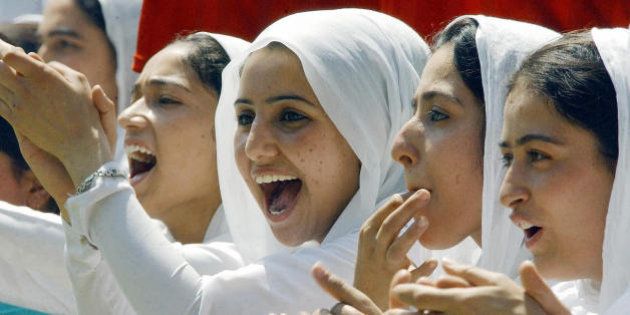 SRINAGAR, INDIA: Indian Kashmiri female Muslim students cheer for their team during a girls cricket match at a woman's college in Srinagar, 06 August 2004. Nuclear rivals India and Pakistan have agreed to prolong a ceasefire in force in disputed Kashmir since last year. AFP PHOTO/Tauseef MUSTAFA (Photo credit should read TAUSEEF MUSTAFA/AFP/Getty Images)