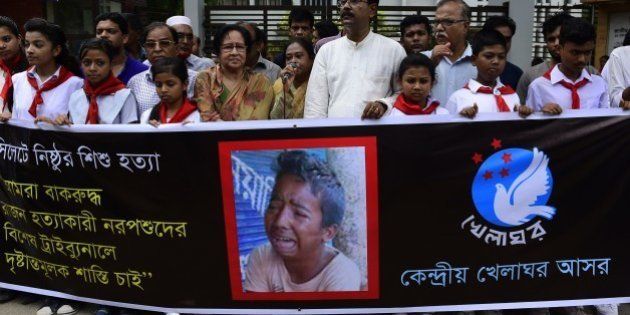 Bangladeshi protesters carry a banner during a demonstration against the lynching of a 13-year-old boy in Dhaka on July 14, 2015. Outrage over the lynching of a 13-year-old boy mounted in Bangladesh July 14, 2015, with more protests over the murder which was captured on video, as one of the suspects confessed after being arrested in Saudi Arabia. Bangladeshi police have now arrested five people over the July 8 killing of Samiul Alam Rajon, who was tied to a pole and then subjected to a sickening assault in which he pleaded for his life. The 28-minute video of Samiul, which went viral after being posted on social media, has sparked an outpouring of anger, with petitions and demonstrations demanding the attackers face the death penalty. AFP PHOTO/ Munir uz ZAMAN (Photo credit should read MUNIR UZ ZAMAN/AFP/Getty Images)