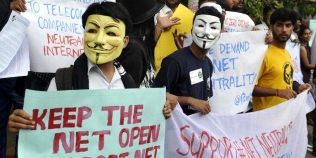 Indian activists wear Guy Fawkes masks as they hold placards during a demonstration supporting 'net neutrality' in Bangalore on April 23, 2015. The activists urged the Indian government to pass legislation to ensure net neutraliy and prevent private service providers from gaining control over the internet. AFP PHOTO / Manjunath KIRAN (Photo credit should read Manjunath Kiran/AFP/Getty Images)