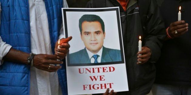 Indian journalists hold candles and a photograph of Akshay Singh during a memorial meeting in Bangalore, India, Monday, July 6, 2015. Singh, an Indian television journalist died under mysterious circumstances Saturday while on assignment covering allegations of a massive scheme to manipulate the results of entrance examinations for government jobs and medical colleges in the central Indian state of Madhya Pradesh. The alleged scam labeled âVyapamâ by Indian media after the Hindi name of the stateâs professional examination board since the story first surfaced in 2013. (AP Photo/Aijaz Rahi)