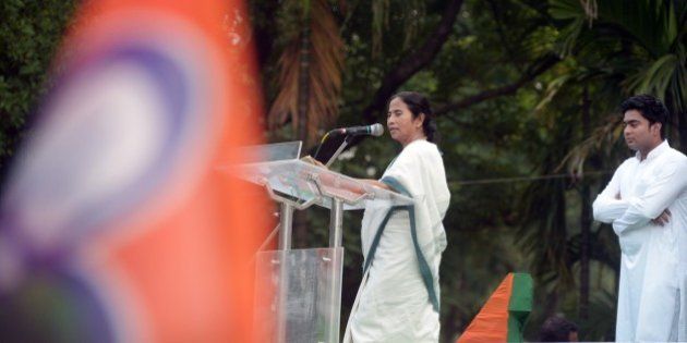 Chief minster of the eastern state of West Bengal and supremo of the Trinamool Congress, Mamata Banerjee (L), watched by party leader and nephew Abhishek Banerjee, delivers her speech after taking part in a rally organised to protest against the central government's Land Acquisition Bill in Kolkata on April 8, 2015. The lower house of the Parliament in March 2015, passed the Right to Fair Compensation and Transparency in Land Acquisition, Rehabilitation and Resettlement (Amendment) Bill, 2015, with nine amendments. However, it was not passed in the Rajya Sabha where Prime Minister Narendra Modi's Bharatiya Janata Party (BJP) is in minority. AFP PHOTO / Dibyangshu Sarkar (Photo credit should read DIBYANGSHU SARKAR/AFP/Getty Images)