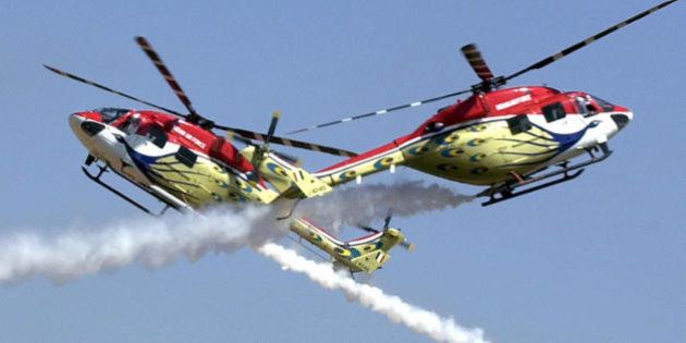 BANGALORE, INDIA: Advanced Light Helicopters (ALH) of the Indian Air Force's Sarang aerobatics team perform during the inaugural function of the Aero India 2005 airshow at the Yelahanka Air Force Station on the outskirts of Bangalore, 09 February 2005. More than 200 foreign aviation firms from 31 countries are showcasing their products in India's hight tech capital at the five day-long Aero India, billed as the largest air show in South Asia. The United States, Britain, France, Russia, Israel, China and Malaysia are among the nations participating in the five day-long biennial show. AFP PHOTO/INDRANIL MUKHERJEE (Photo credit should read INDRANIL MUKHERJEE/AFP/Getty Images)
