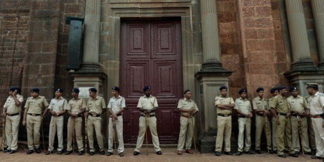 Indian policemen stand guard outside the Basilica of Bom Jesus before the start of a procession carrying the remains of St. Francis Xavier in Goa on November 22, 2014. The 17th exposition of the body of St Francis Xavier will be held from November 22 to January 4, 2015 in Goa, for veneration by pilgrims. AFP PHOTO/ PUNIT PARANJPE (Photo credit should read PUNIT PARANJPE/AFP/Getty Images)