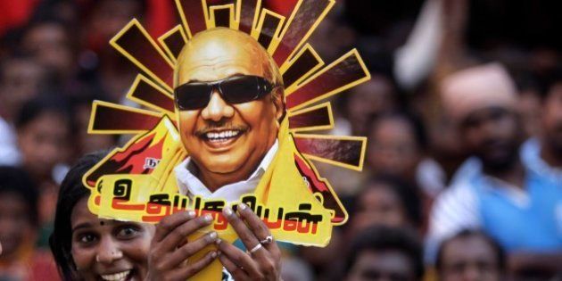 A supporter holds up a cutout with a portrait of Dravida Munnetra Kazhagam (DMK) party chief M. Karunanidhi during an election rally in Chennai, India, Tuesday, April 22, 2014. The multiphase voting across the country runs until May 12, with results for the 543-seat lower house of Parliament announced May 16. (AP Photo/Arun Sankar K.)