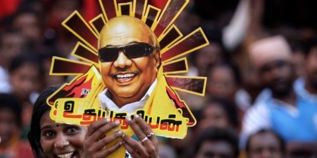 A supporter holds up a cutout with a portrait of Dravida Munnetra Kazhagam (DMK) party chief M. Karunanidhi during an election rally in Chennai, India, Tuesday, April 22, 2014. The multiphase voting across the country runs until May 12, with results for the 543-seat lower house of Parliament announced May 16. (AP Photo/Arun Sankar K.)