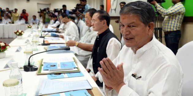 Uttarakhand Chief Minister Harish Rawat gestures during a meeting at party headquarters in New Delhi on June 9, 2015. Congress President Sonia Gandhi, Vice President Rahul Gandhi and General Secretaries met with the Chief Ministers of congress ruled states, to form a political strategy to take on the NDA Government at the Centre for its attitude towards Congress-ruled and other non- BJP states. AFP PHOTO/PRAKASH SINGH (Photo credit should read PRAKASH SINGH/AFP/Getty Images)