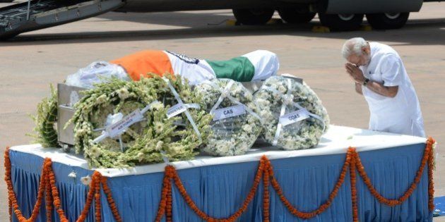 Indian Prime Minister Narendra Modi pays his last respects at the body of former Indian President APJ Abdul Kalam at Palam Airforce Station in New Delhi on July 28, 2915, after its arrival from Guwahati. India's former president and top scientist A. P. J. Kalam, who played a lead role in the country's nuclear weapons tests, died July 28, a hospital official said. He was 83. Kalam collapsed during a lecture at a management institute in the northeastern Indian city of Shillong, and was declared dead on arrival by doctors at Bethany hospital. AFP PHOTO / PRAKASH SINGH (Photo credit should read PRAKASH SINGH/AFP/Getty Images)