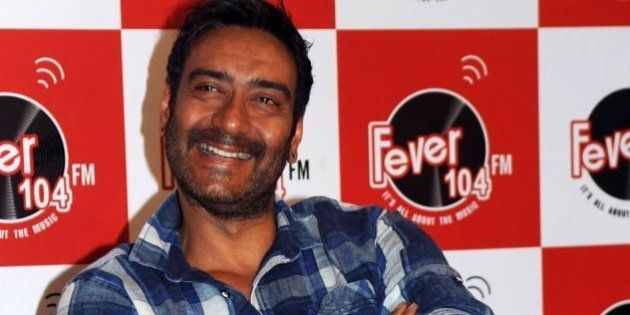 Indian Bollywood actor Ajay Devgn poses as he takes part in a promotional event visit to Fever 104 FM Studios ahead of the forthcoming Hindi film Drishyam directed by Nishikant Kamat in Mumbai on July 8, 2015. AFP PHOTO/STR (Photo credit should read STRDEL/AFP/Getty Images)
