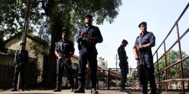 Indian police personnel stand alert at the entrance to Central Jail in Nagpur on July 29, 2015, where...