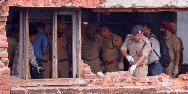 Indian police inspect a the building after armed militants attacked the police station in Dinanagar town, in the Gurdaspur district of Punjab state on July 27, 2015. Indian security forces were battling an armed attack on a police station near the Pakistan border in which at least five people have been killed. AFP PHOTO/ NARINDER NANU (Photo credit should read NARINDER NANU/AFP/Getty Images)