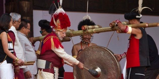 Indian Prime Minister Narendra Modi, third right, dressed in Naga attire hits a traditional musical instrument to inaugurate the Hornbill festival in Kisama village in Nagaland, India, Monday, Dec. 1 2014. The 10-day long festival named after the Hornbill bird is one of the biggest festivals that showcases the rich tradition and cultural heritage of the indigenous Nagas of Indiaâs northeast. (AP Photo/Anupam Nath)