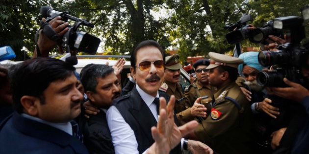 FILE - In this Tuesday, March 4, 2014 file photo, head of Sahara India conglomerate Subrata Roy speaks to the media as he arrives at the Supreme Court for a hearing in New Delhi, India. India's Supreme Court has rejected an appeal by the Indian tycoon accused of a multibillion dollar fraud to be released from jail and allowed house arrest. Roy has been jailed since the end of February on charges that his company failed to return billions of dollars to investors. (AP Photo/Altaf Qadri, File)