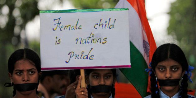 Indian schoolgirls hold a placard and participate in a silent rally against the rape of a 5-year-old girl in New Delhi, in Hyderabad, India, Tuesday, April 23, 2013. A second suspect was arrested Monday in the rape of a 5-year-old girl who New Delhi police said was left for dead in a locked room, a case that has brought a new wave of protests against how Indian authorities handle sex crimes. (AP Photo/Mahesh Kumar A.)