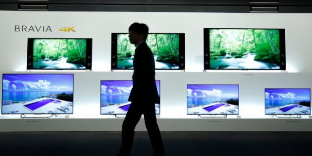 An attendant walks past Sony Corp. Bravia 4K liquid crystal display (LCD) televisions displayed at a launch event in Tokyo, Japan, on Wednesday, May 13, 2015. Sony's TV making unit had a profit of 8.3 billion yen in the year ended March -- its first in 11 years. Photographer: Kiyoshi Ota/Bloomberg via Getty Images