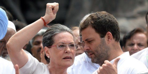 Congress Party President Sonia Gandhi (L) talks with the party vice president and son Rahul Gandhi (R) as they join other Congress Party members of parliament to shout slogans against Prime Minister Narendra Modi and the NDA government at Parliament House in New Delhi on August 5, 2015. Members of the Congress Party, supported by other parties, protested against the suspension of 25 Congress MPs for ''willfully'' disrupting proceedings in the Indian parliament. AFP PHOTO/PRAKASH SINGH (Photo credit should read PRAKASH SINGH/AFP/Getty Images)