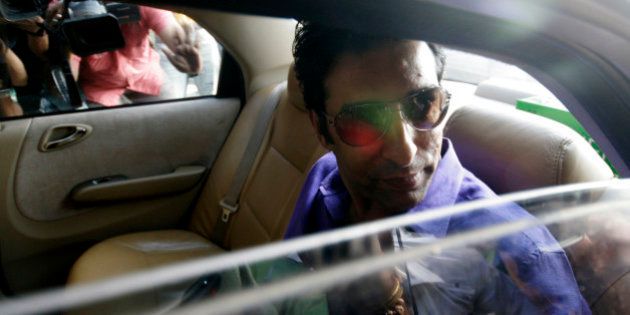 Former Pakistan cricket captain Wasim Akram arrives for a meeting with Indian Premier League team Kolkata Knight Riders owner and Bollywood actor Shah Rukh Khan in Mumbai, India, Sunday, Aug.30, 2009. Akram is one of the leading contenders for the job of the coach of the Knight Riders. (AP Photo/Dhiraj Singh)