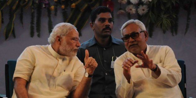 PATNA, INDIA - JULY 25: Prime Minister Narendra Modi interacts with Bihar Chief Minister Nitish Kumar at 87th ICAR (Indian Council of Agricultural Research) Foundation Day Celebrations, SKM Hall, on July 25, 2015 in Patna, India. Modi said the nation can no longer wait for the second green revolution, which must come from eastern India. He said India must aim to become totally self-sufficient in the agriculture sector. During a rally, Modi targeted Bihar Chief Minister Nitish Kumar for allying with RJD, saying he was trying to drag the state back to the 'jungle raj', and asked the voters to reject such people as they 'cannot be trusted' again and elect NDA with a two-third majority for changing Bihar's fate. (Photo by AP Dube/Hindustan Times via Getty Images)
