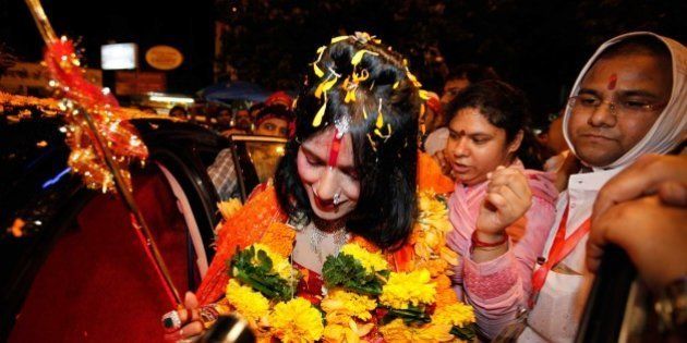 MUMBAI, INDIA - AUGUST 27: (file photo) Radhe Maa, self-proclaimed Godwoman, visits Siddhivinayak Temple, Prabhadevi, on August 27, 2012 in Mumbai, India. Radhe Maa has been accused of dowry harassment by a woman, who has filed an FIR or police complaint in Mumbai. The woman has said that her husband's family tortured her on the godwoman's advice and forced her to serve Radhe Maa, do chores for her and give her massages. Radhe Maa's real name is Sukhvinder Kaur. She was born on 4 April 1965 in Dorangala village of Gurdaspur district in Punjab. Her followers state that she was drawn to spirituality as a child, and spent a lot of time at the Kali temple in her village. However, according to people of her village, she did not show any spiritual leanings as a child. At the age of 23, she became a disciple of Mahant Ram Deen Das of 1008 Paramhans Bagh Dera Mukerian in Hoshiarpur district. Ram Deen Das oversaw her deeksha (initiation ceremony), and gave her the title Radhe Maa. She is usually seen in glittering red bridal wear, heavy jewellery and layers of make-up. Thick garlands and a trident complete the picture. She used to stitch clothes to support her husband's small income. (Photo by Vijayanand Gupta/Hindustan Times via Getty Images)