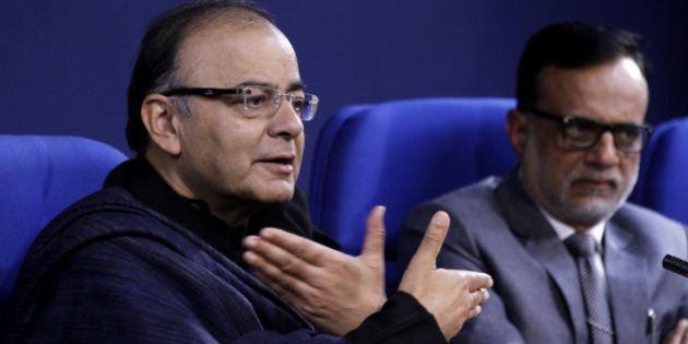 NEW DELHI, INDIA - JANUARY 20: Union Finance Minister Arun Jaitley and Financial Services Secretary Hasmukh Adhia during press conference at Shastri Bhawan on January 20, 2015 in New Delhi, India. As many as 11.5 crore bank accounts have been opened under the Pradhan Mantri Jan Dhan Yojana, exceeding the enhanced target of 10 crore and covering 99.74 per cent of households. A Guinness Book World record has been created for most bank accounts opened in one week as part of the Financial Inclusion Campaign is 18,096,130 and was achieved by the Department of Financial Services, Government of India from August 23 to 29, 2014. (Photo by Virendra Singh Gosain/Hindustan Times via Getty Images)
