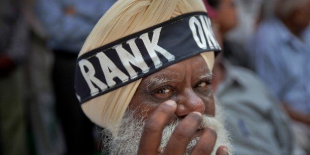 A former Sikh army soldier wears a headband around his turban during a protest in New Delhi, India, Sunday, July 26, 2015. The former soldiers are protesting against the delay in implementing the âOne Rank One Pensionâ scheme by the Indian government. (AP Photo/Tsering Topgyal)