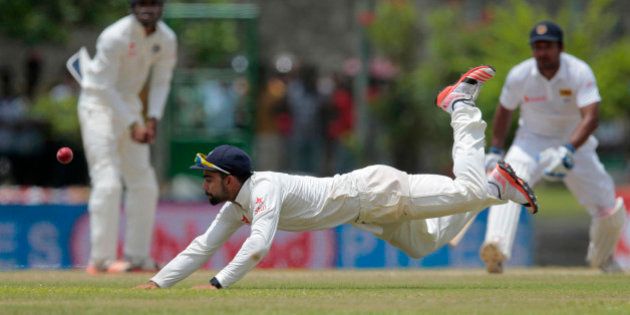 India's Virat Kohli dives to field a ball during the third day of the first cricket test match between India and Sri Lanka in Galle, Sri Lanka, Friday, Aug. 14, 2015. (AP Photo/Eranga Jayawardena)