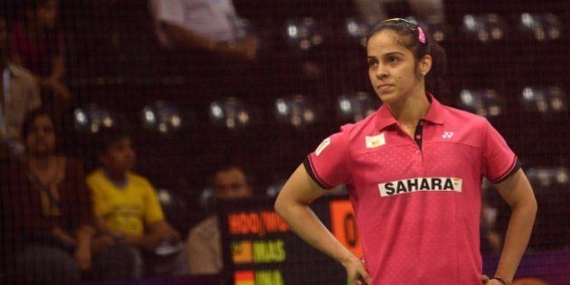 In this photograph taken on March 25, 2015, Saina Nehwal of India reacts during her women's badminton singles match against Riay Mukherjee of India at the Yonex-Sunrise India Open 2015 at the Siri Fort Sports Complex in New Delhi. Badminton star Saina Nehwal has shrugged off mounting pressure over whether she will become the first Indian woman ever to clinch the world number one ranking, at the Indian Open in New Delhi. Nehwal, currently number two after reaching the prestigious All-England Championship final this month, is expected to snatch the number one spot if she wins the tournament in front of a home crowd. AFP PHOTO / SAJJAD HUSSAIN (Photo credit should read SAJJAD HUSSAIN/AFP/Getty Images)