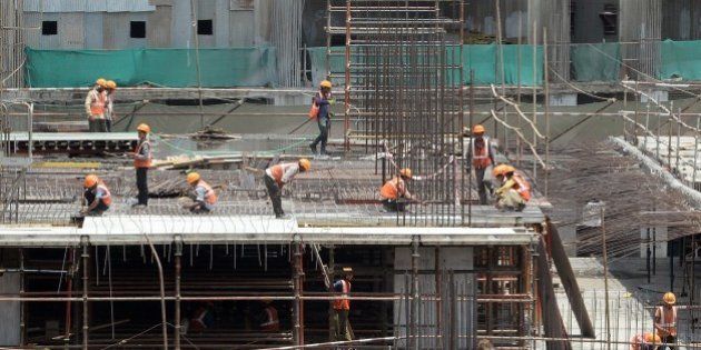 Indian labourers work at the site of an under-construction apartment building in Mumbai on June 1, 2015. AFP PHOTO/ Indranil MUKHERJEE (Photo credit should read INDRANIL MUKHERJEE/AFP/Getty Images)