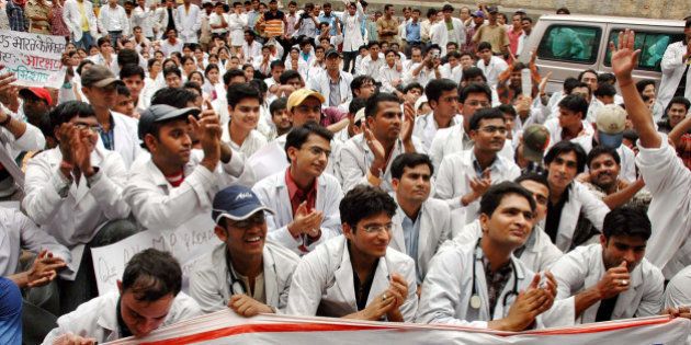 Medical students applaud a speaker, unseen, during a protest against an affirmative action program, at the Banaras Hindu University in Varanasi, India, Monday, May 15, 2006. The government plans to increase quotas for lower caste students in medical, engineering and other professional colleges from 22.5 percent to 49.5 percent. (AP Photo/Rajesh Chaurasia)