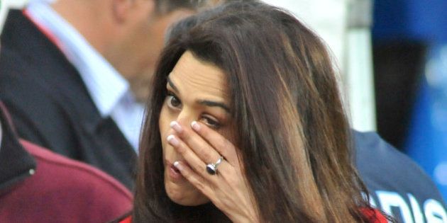 Bollywood star Preity Zinta wipes a tear from her eye after hearing that two of IPL Punjab Kings players Jawardne and Sangakara were injured in a terrorist shooting in Pakistan while she was attending the New Zealand and India 1st one day international cricket match at McLean Park, Napier, New Zealand, Tuesday, March 3, 2009. A dozen masked gunmen armed with rifles and rocket launchers attacked the Sri Lankan cricket team as it traveled to a match in Pakistan on Tuesday, wounding several players and killing five police officers, officials said. (AP Photo/NZPA, Ross Setford) ** NEW ZEALAND OUT **