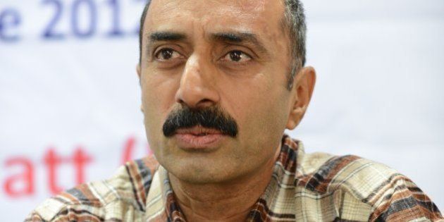IPS Sanjiv Bhatt gestures after receiving the 5th Mother Teresa Award for Social Justice in Ahmedabad on December 31, 2012. Bhatt was honoured for his accomplishment for standing against communal forces to ensure the protection of the vulnerable and insecure minorities. AFP PHOTO / Sam PANTHAKY (Photo credit should read SAM PANTHAKY/AFP/Getty Images)