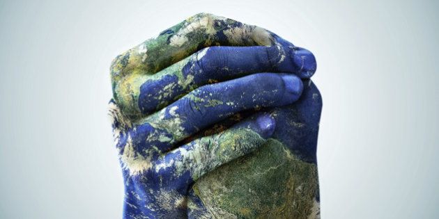 A cropped shot of hands painted to look like the earth