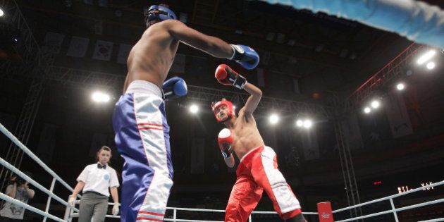 INCHEON, SOUTH KOREA - JULY 03: Thanh Tran (Red) of Vietnam compete with Kumar Visal (Blue) of India in the Kickboxing, Full Contact Men's 71kg Round of 16 at Dowon Gymnasium during day five of the 4th Asian Indoor Martial Arts Games on July 3, 2013 in Incheon, South Korea. (Photo by Chung Sung-Jun/Getty Images)