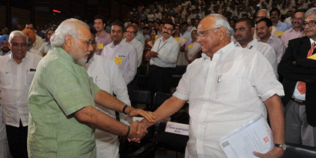 Gujarat state Chief Minister Narendra Modi (L) and Indian Union Agriculture Minister Sharad Pawar greet each other before the launch of the 'Mission Milk' National Dairy Plan at the National Dairy Development Board, NDDB, Amul in Anand town, some 75 kms from Ahmedabad, on April 19, 2012. Indian Union Agriculture Minister Sharad Pawar launched the National Dairy Plan in the presence of Gujarat state Chief Minister, Narendra Modi. AFP PHOTO / Sam PANTHAKY (Photo credit should read SAM PANTHAKY/AFP/Getty Images)