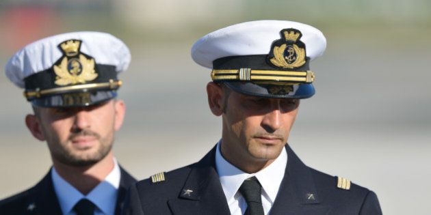 (FILES) In this photograph taken on December 22, 2012, Italian marines Massimiliano Latorre (R) and Salvatore Girone (L) arrive at Ciampino airport near Rome, on December 22, 2012. India's Supreme Court ruled February 22, 2013 that two Italian marines accused of murdering Indian fishermen while guarding an oil tanker could return home to cast their votes in upcoming national elections. The marines are suspected of shooting dead two fishermen off India's southwestern coast near the port city of Kochi in February 2012, when a fishing boat came close to the Italian oil tanker they were guarding. AFP PHOTO/ VINCENZO PINTO/ FILES (Photo credit should read VINCENZO PINTO/AFP/Getty Images)