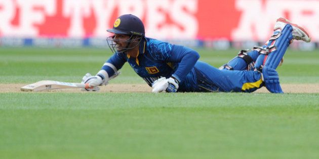 Sri Lanka's Kumar Sangakkara dives to make his ground against Engalnd during their Cricket World Cup match in Wellington, New Zealand, Sunday, March 1, 2015. (AP Photo Ross Setford)