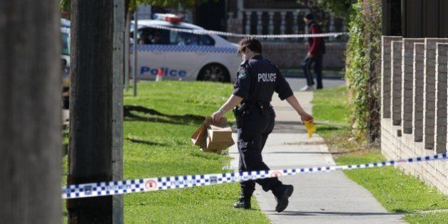 (AUSTRALIA & NEW ZEALAND OUT) Police gather evidence from a block of units in Cairds Avenue in Bankstown, Sydney, the morning after a siege in which a policemen, Bill Crews, was fatally shot in the head and neck. (Photo by Fairfax Media via Getty Images)