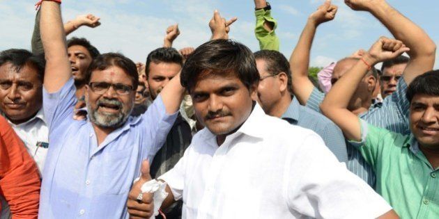 Hardik Patel (C), an organiser of the Patidar community, gathers with group members for a rally demanding 'Other Backward Class' (OBC) status in Ahmedabad on August 23, 2015. OBC members have urged the Gujarat government not to grant the Patel, or Patidar, community the status, which grants official protection of the members' social and educational development. AFP PHOTO / Sam PANTHAKY (Photo credit should read SAM PANTHAKY/AFP/Getty Images)