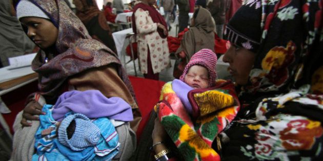 Indian mothers hold their babies, born on 12/12/12 at a hospital in Jammu, India, Wednesday, Dec. 12, 2012. The date 12/12/12, seen as auspicious by astrologers, saw an influx of mothers to local hospitals looking to give birth on the date which won't happen again for nearly 100 years, local media reported. (AP Photo/Channi Anand)