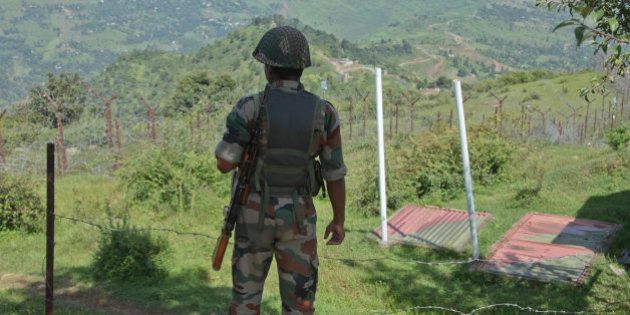 An Indian army soldier guards near fencing on the line of control near Balakot sector in Poonch, Jammu and Kashmir, India, Monday, Aug.17, 2015. Despite a 2003 cease-fire, the two neighbors regularly trade fire, the latest coming as India celebrated Independence Day on Saturday. Pakistan observed it a day earlier. (AP Photo/Channi Anand)