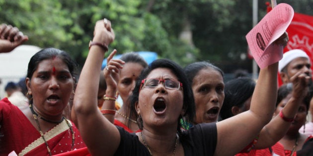 MUMBAI, INDIA - AUGUST 21: Activists and workers of various political parties and unions raising slogans against the government following the murder of social activist Dr Narendra Dabholkar at Churchgate on August 21, 2013 in Mumbai, India. Narendra Dabholkar was shot dead by two men on a motorcycle while he was out for a morning walk near Omkareshwar Temple in Pune. Renowned rationalist Dabholkar had relentlessly campaigned for a law against superstition and black magic and was opposed by Hindu organization. The state government today cleared an Anti-Superstition and Black Magic Ordinance to replace a Bill that had been approved by the cabinet but had lapsed before it could be taken up in the assembly. The Bill has been pending for eight years. (Photo by Vijayaannd Gupta/Hindustan Times via Getty Images)