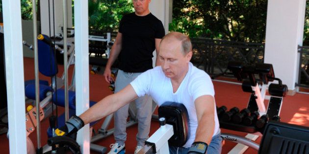 Russian President Vladimir Putin, foreground, and Prime Minister Dmitry Medvedev exercise during their meeting at the Black Sea resort of Sochi, Russia, Sunday, Aug. 30, 2015. (AP Photo/RIA Novosti, Mikhail Klimentyev, Presidential Press Service)