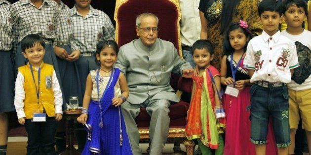 NEW DELHI, INDIA - AUGUST 29: President of India Pranab Mukherjee meeting the children on the auspicious occasion of Raksha Bandhan at Rashtrapati Bhavan on August 29, 2015 in New Delhi, India. On Raksha Bandhan, sisters tie a rakhi (sacred thread) on her brother's wrist, which symbolizes the sister's love and prayers for her brother's well-being and the brother's lifelong vow to protect her. (Photo by Raj K Raj/Hindustan Times via Getty Images)