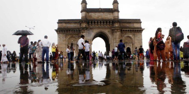 MUMBAI, INDIA - JULY 29: People enjoy after heavy rain at Gateway of India on July 29, 2015 in Mumbai, India. Heavy rains caused major waterlogging in many areas, leaving residents and commuters stranded, and causing a huge traffic gridlock. Waterlogging in many areas has led BEST to divert bus routes and trains being stalled as tracks are under water. The temperature here dropped to 28.5 degrees Celsius due to the rain, according to the weather department. (Photo by Arijit Sen/Hindustan Times via Getty Images)