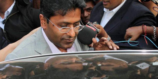 Indian Premier League (IPL) Chairman Lalit Modi prepares to enter a car after his arrival at the airport in Mumbai, India, Tuesday, April 20, 2010. Top cricket officials hope to resolve next week the crisis facing the IPL, including the future of Modi, beleaguered by allegations of corruption in an auction to add a new team to the lucrative tournament. (AP Photo)