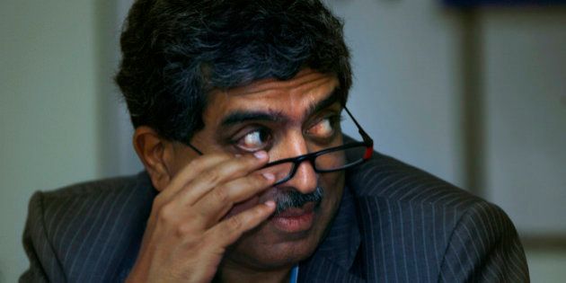 Nandan Nilekani, left, Chairperson Unique Identification Authority of India, a new government office that plans to issue national identity cards to all 1.2 billion Indian citizens, looks on during an event in New Delhi, India, Thursday, July 16, 2009. (AP Photo/Manish Swarup)