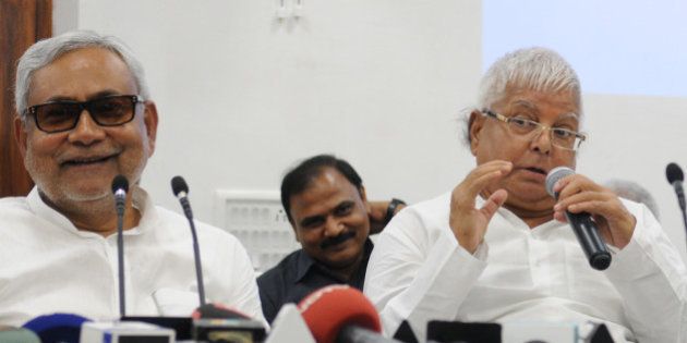 PATNA, INDIA - AUGUST 12: Bihar Chief Minister and JD(U) leader Nitish Kumar with RJD Chief Lalu Yadav addressing a joint press conference to announce Maha Gathbandhan on August 12, 2015 in Patna, India. The RJD and JD-U announced that they will contest 100 seats each in the Bihar assembly election, leaving 40 seats to the Congress and three to the NCP. (Photo by AP Dube/Hindustan Times via Getty Images)